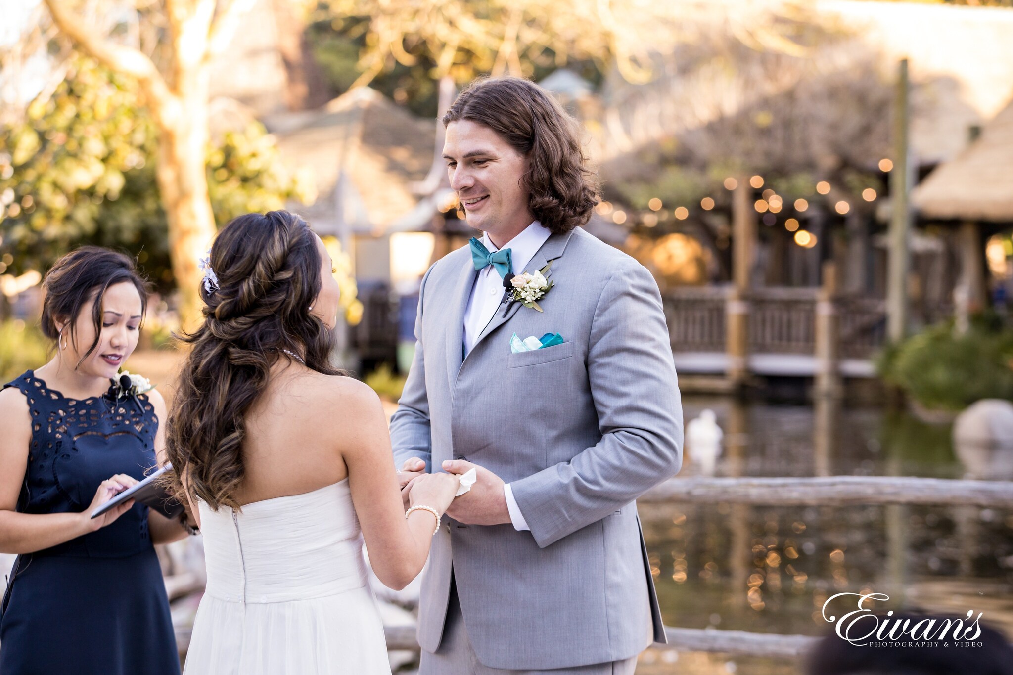 man in blue suit jacket kissing woman in white dress