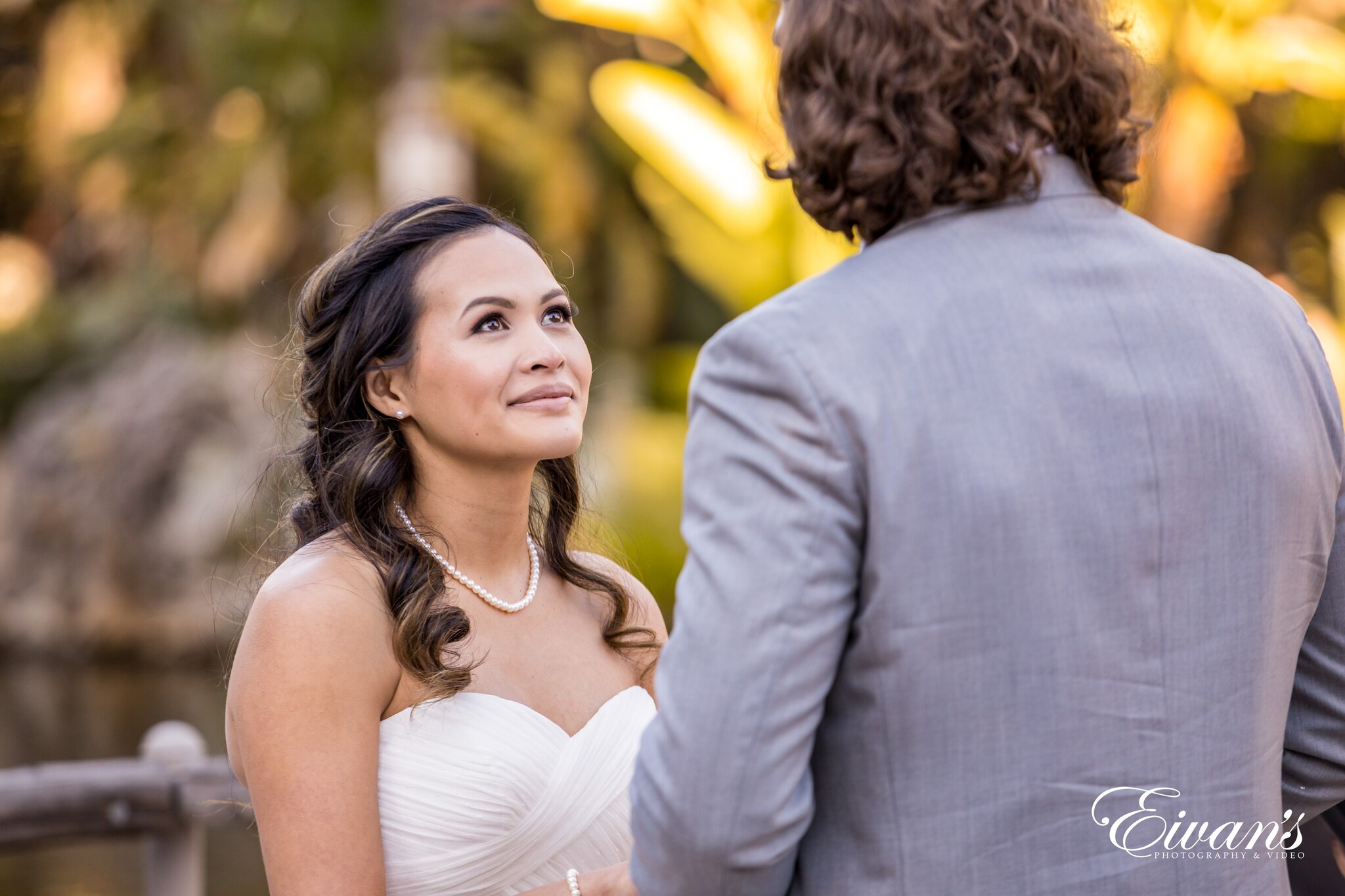 woman in white wedding dress smiling beside man in gray suit