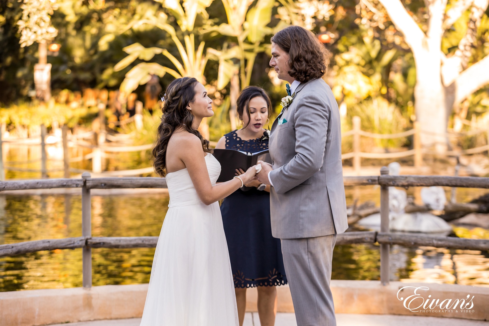 man in gray suit jacket kissing woman in black and white floral dress