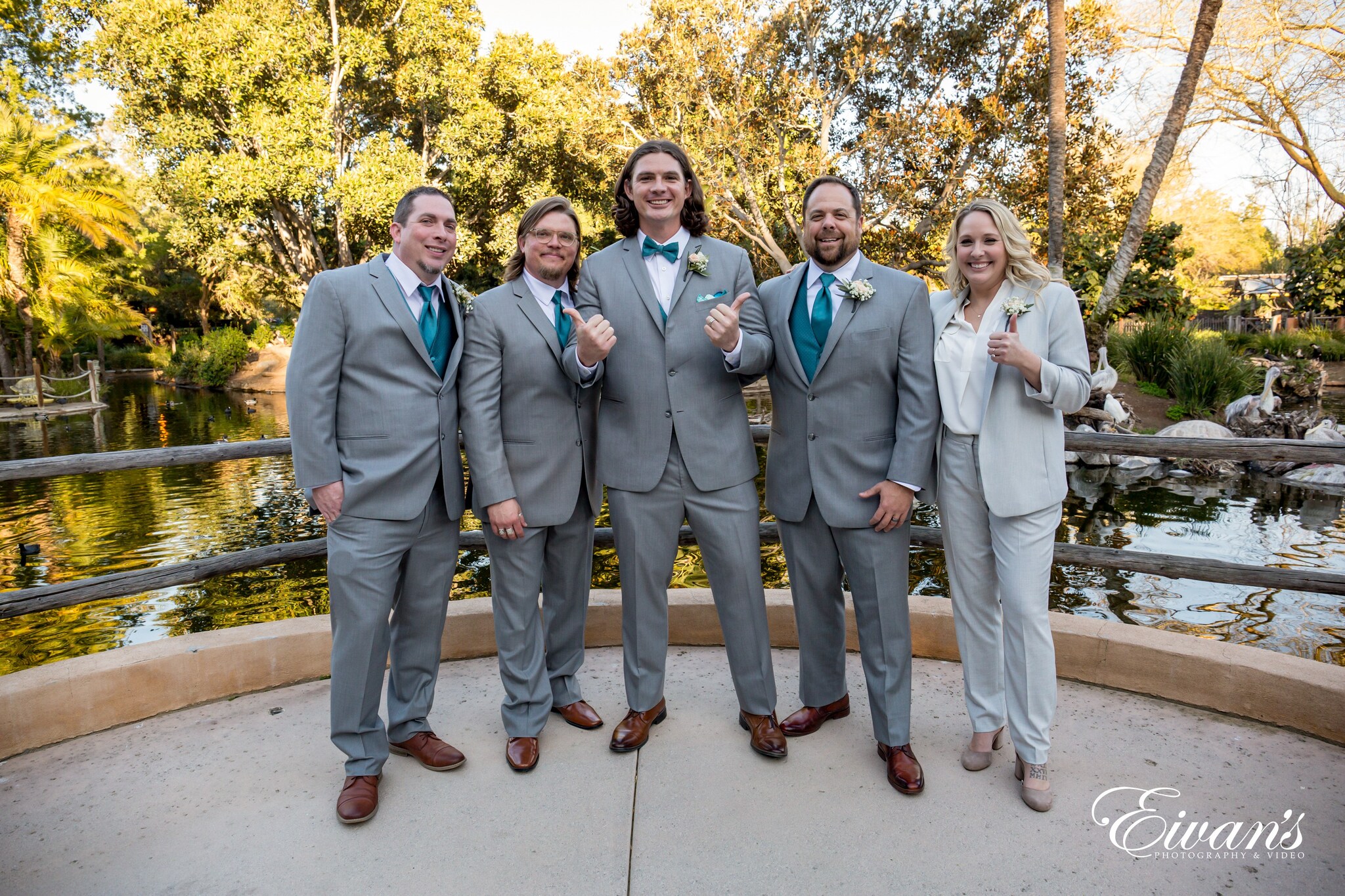 3 men in gray suit standing beside woman in gray blazer