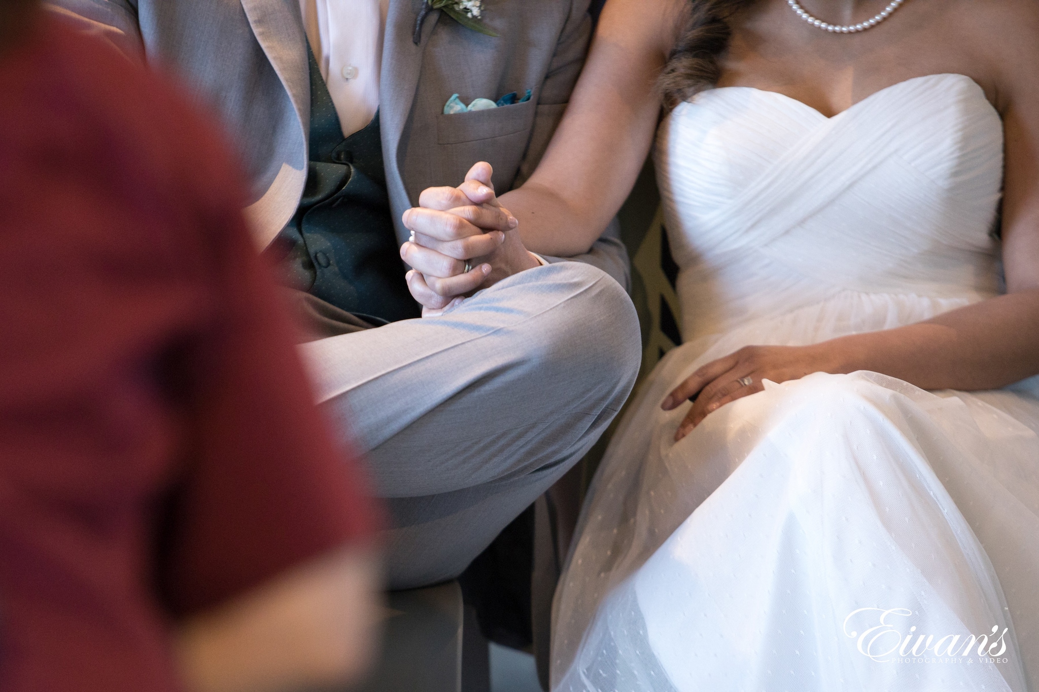 man in gray suit sitting beside woman in white dress