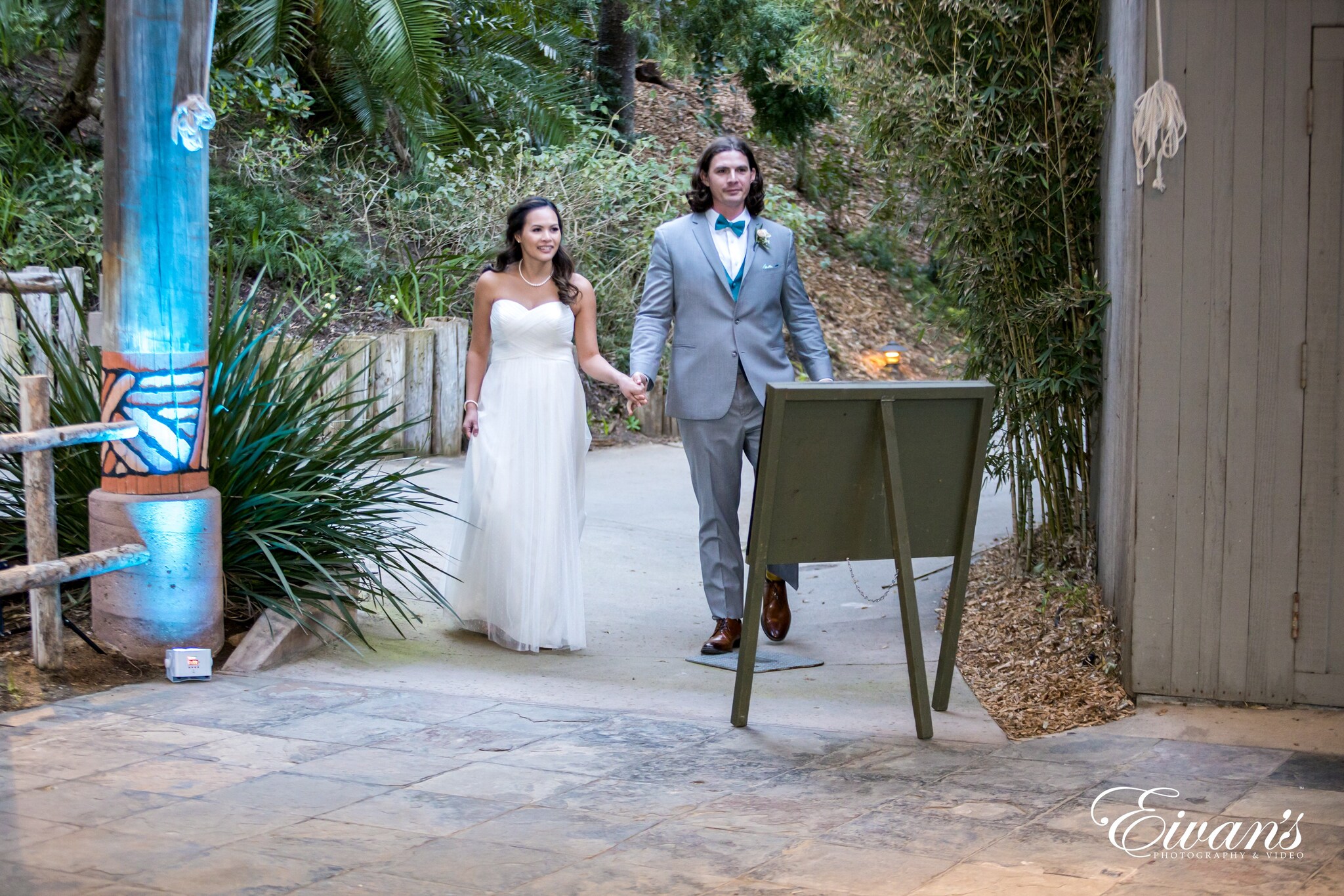 woman in white wedding gown standing beside man in gray suit jacket