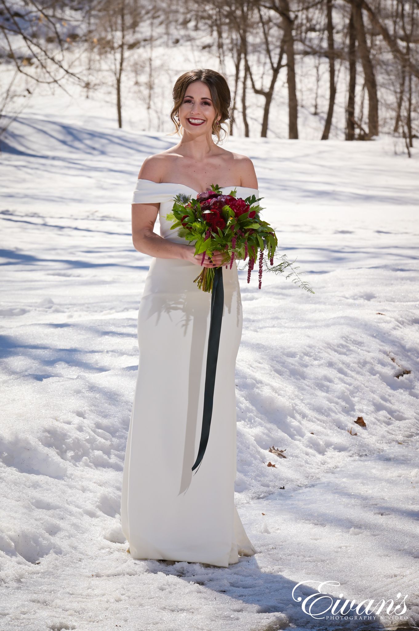 woman in white dress holding bouquet of flowers